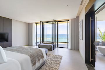 a bedroom with a view of the ocean