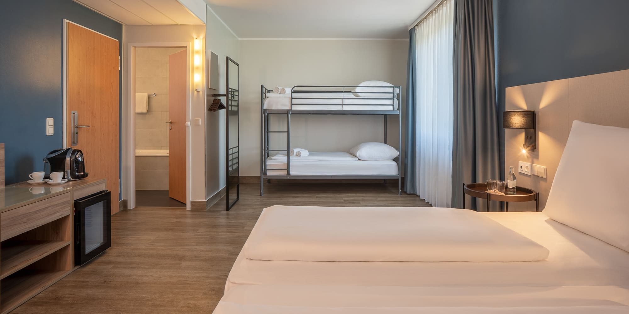 a room with bunk beds and a lamp