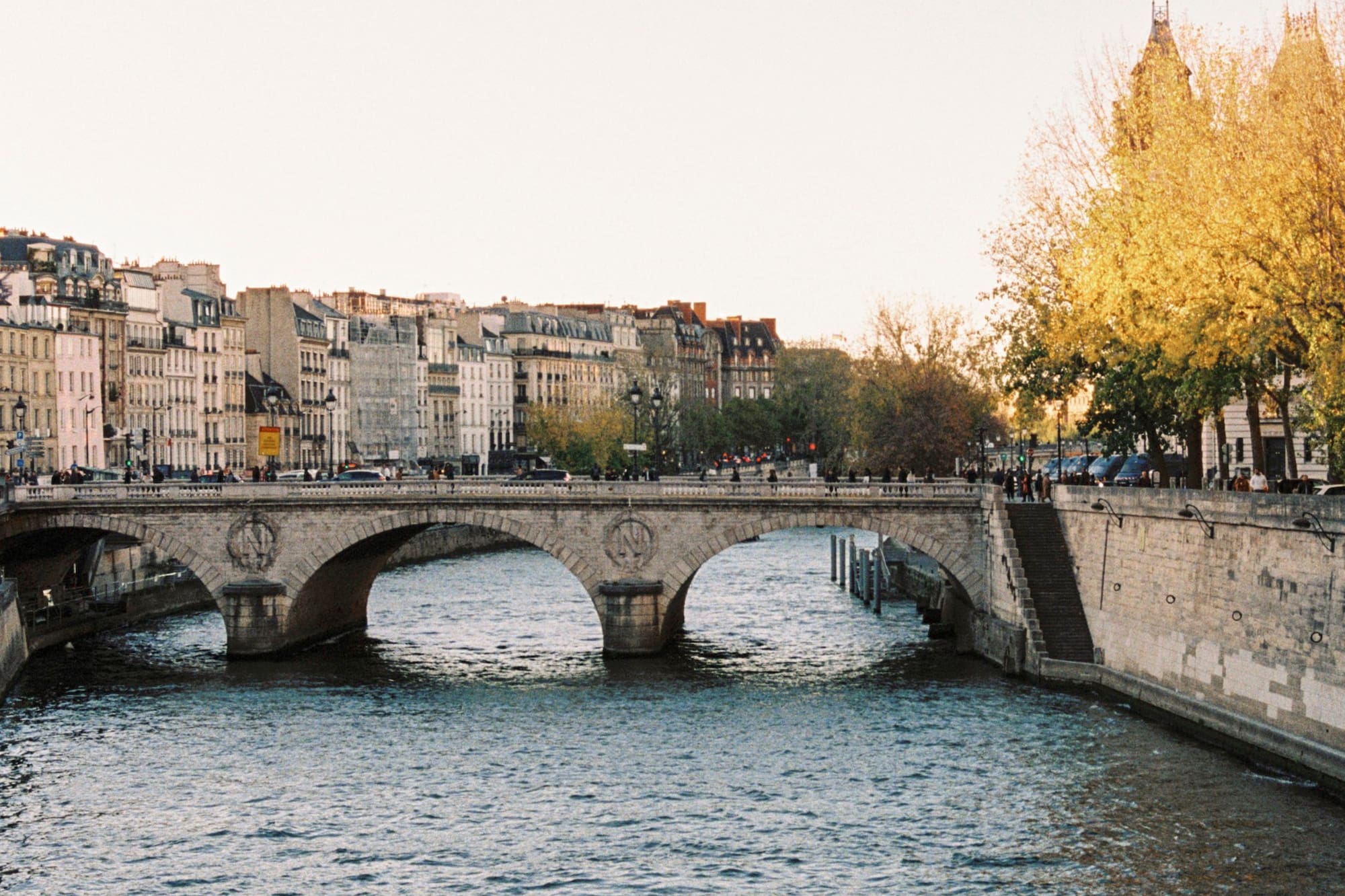a bridge over a river with buildings in the background