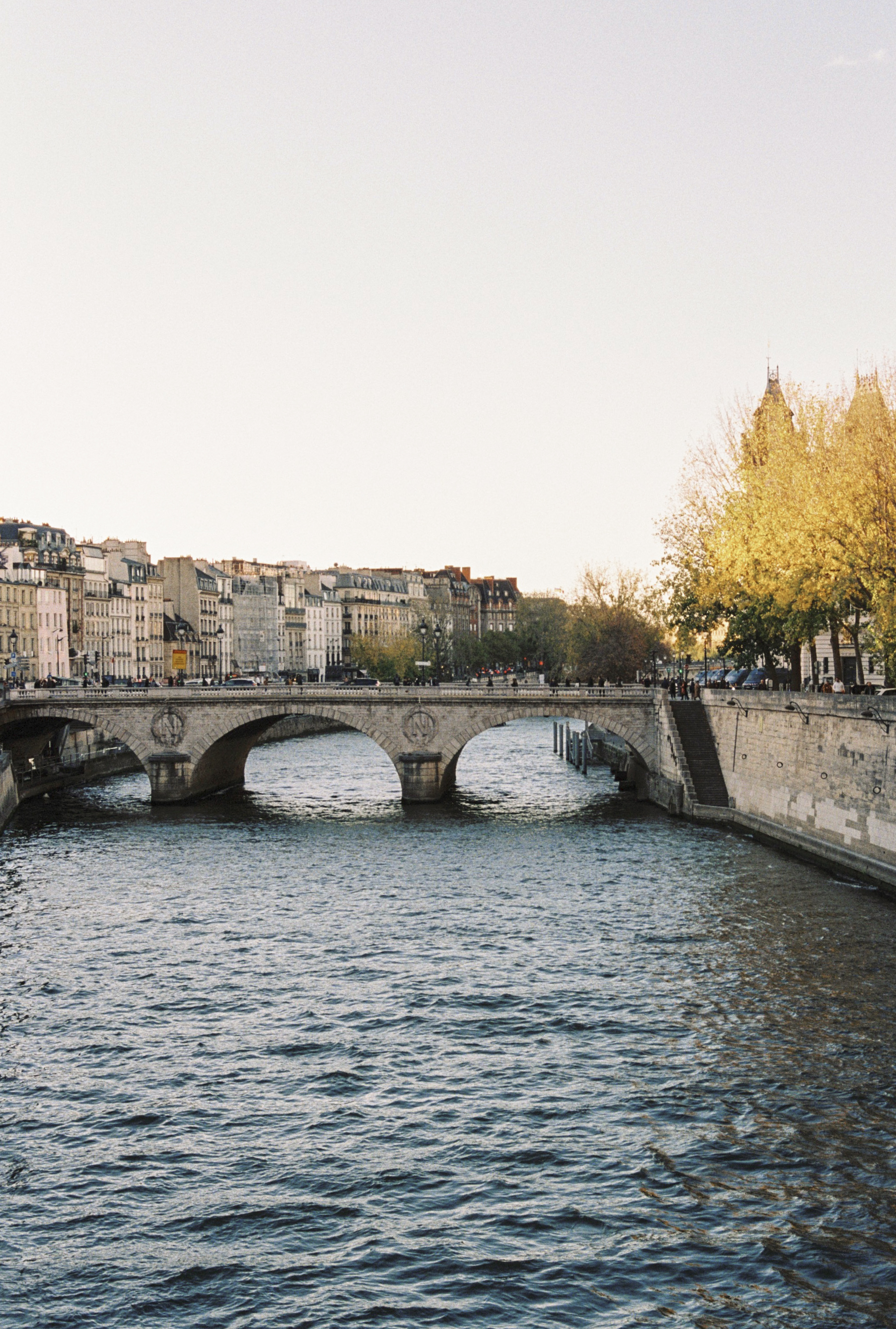 a bridge over a river with buildings in the background