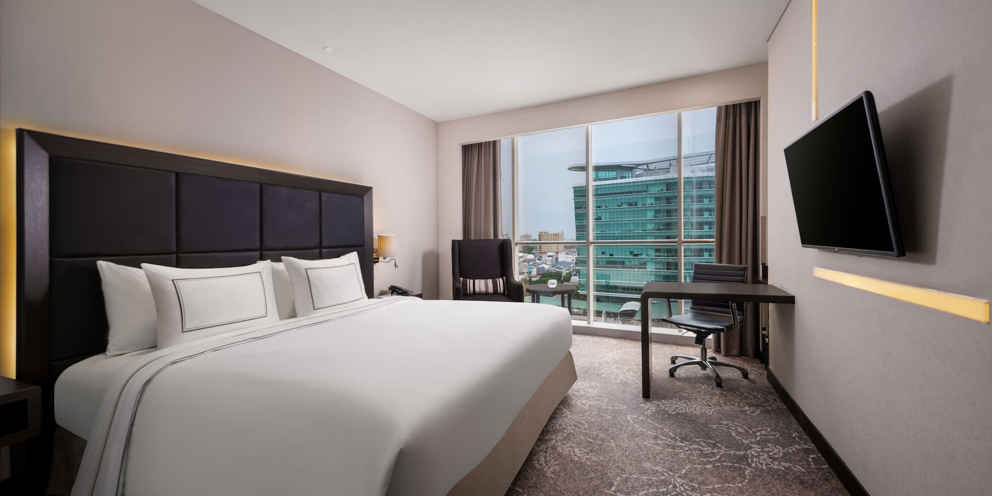 a hotel room with a large bed and a television