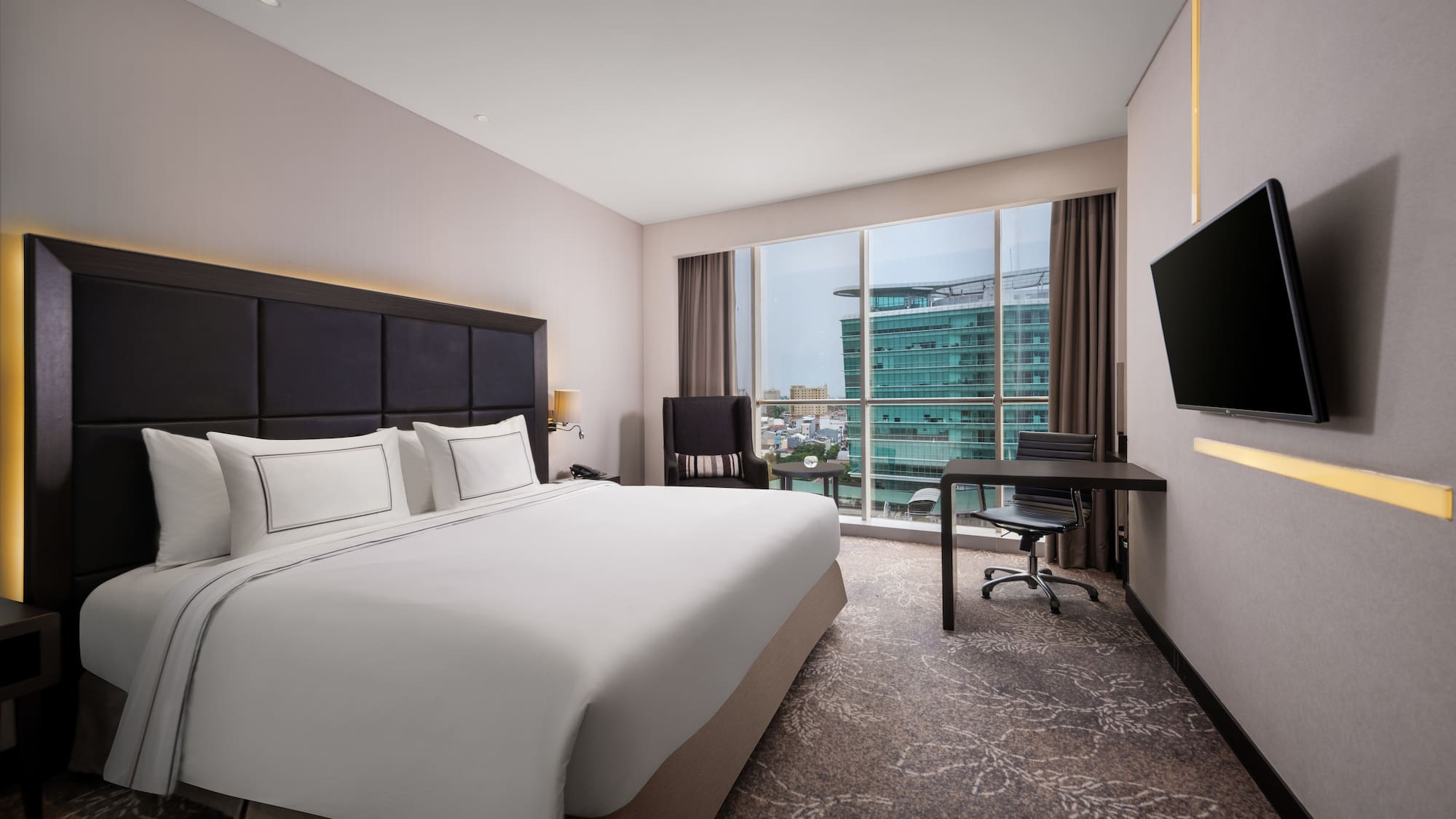 a hotel room with a large bed and a television