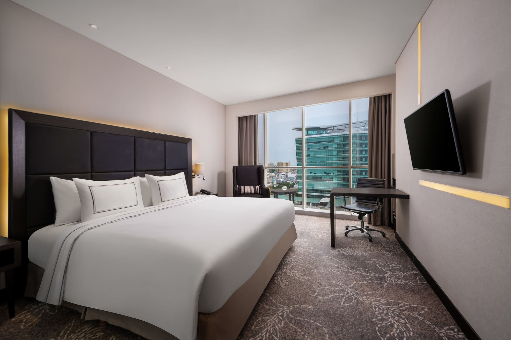 a hotel room with a large bed and a television