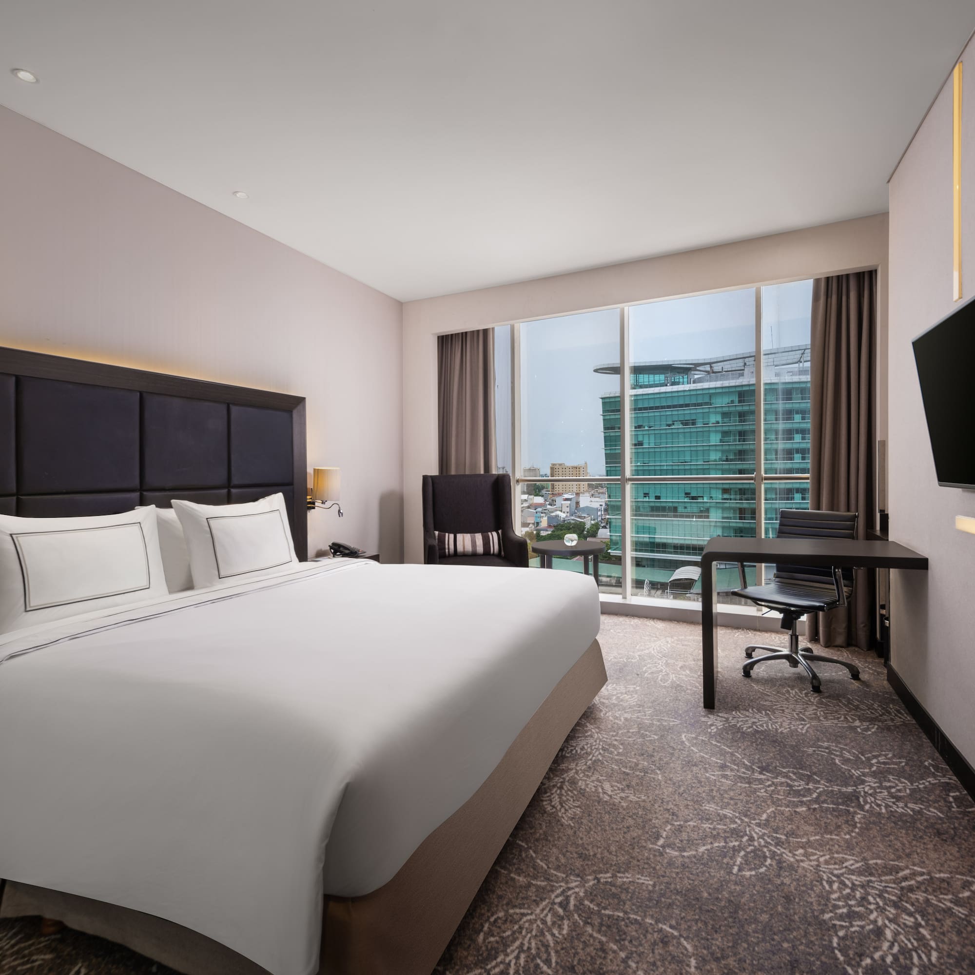 a hotel room with a large bed and a television