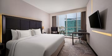 a hotel room with a large bed and a television