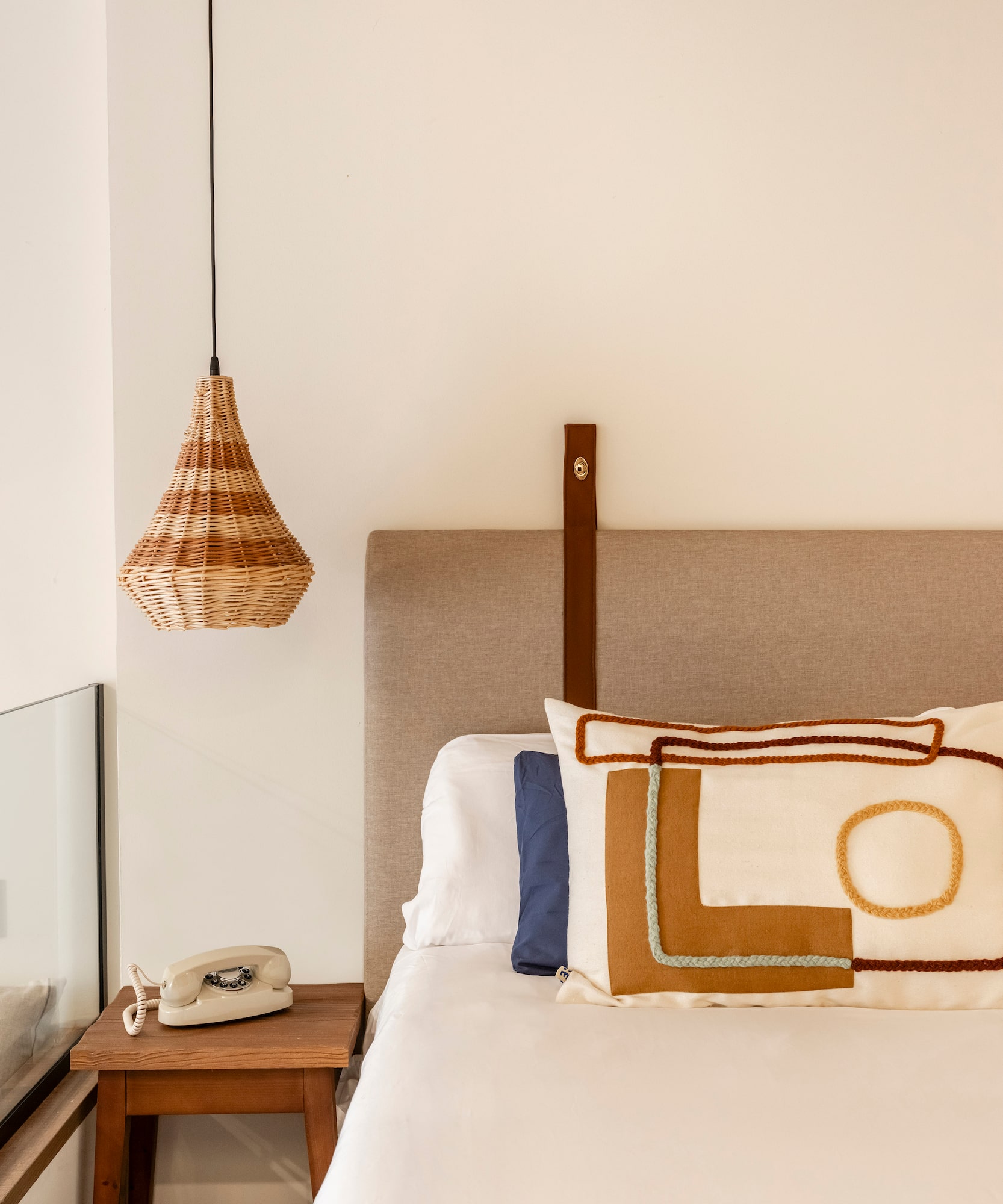 a bed with a pillow and a telephone