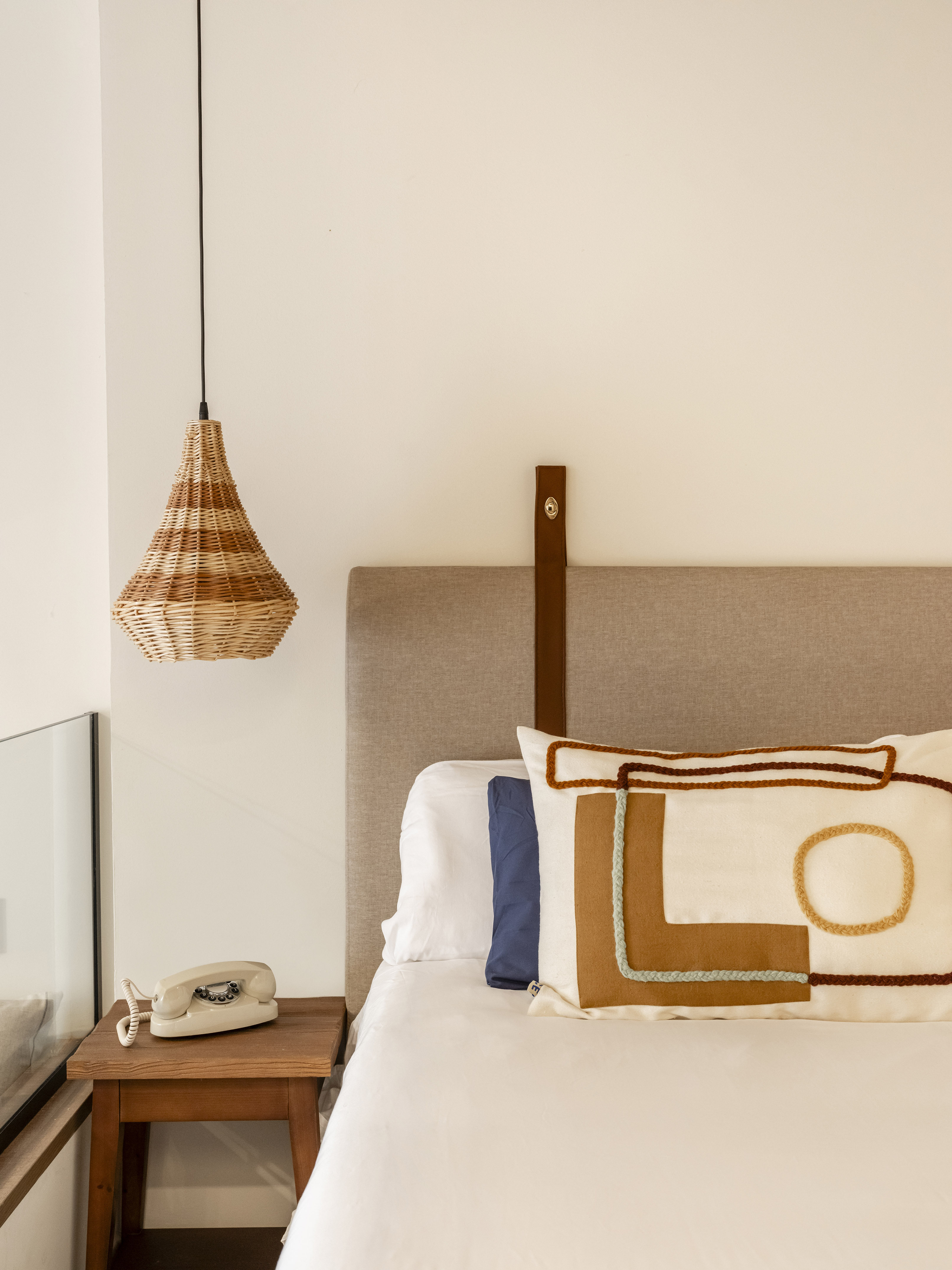 a bed with a pillow and a telephone