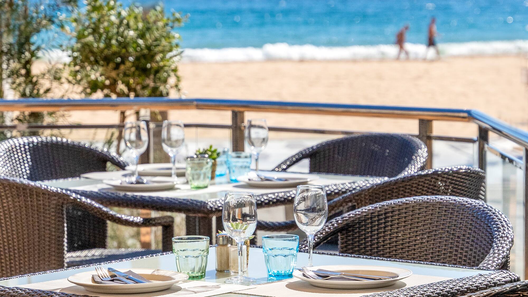 a table and chairs on a beach