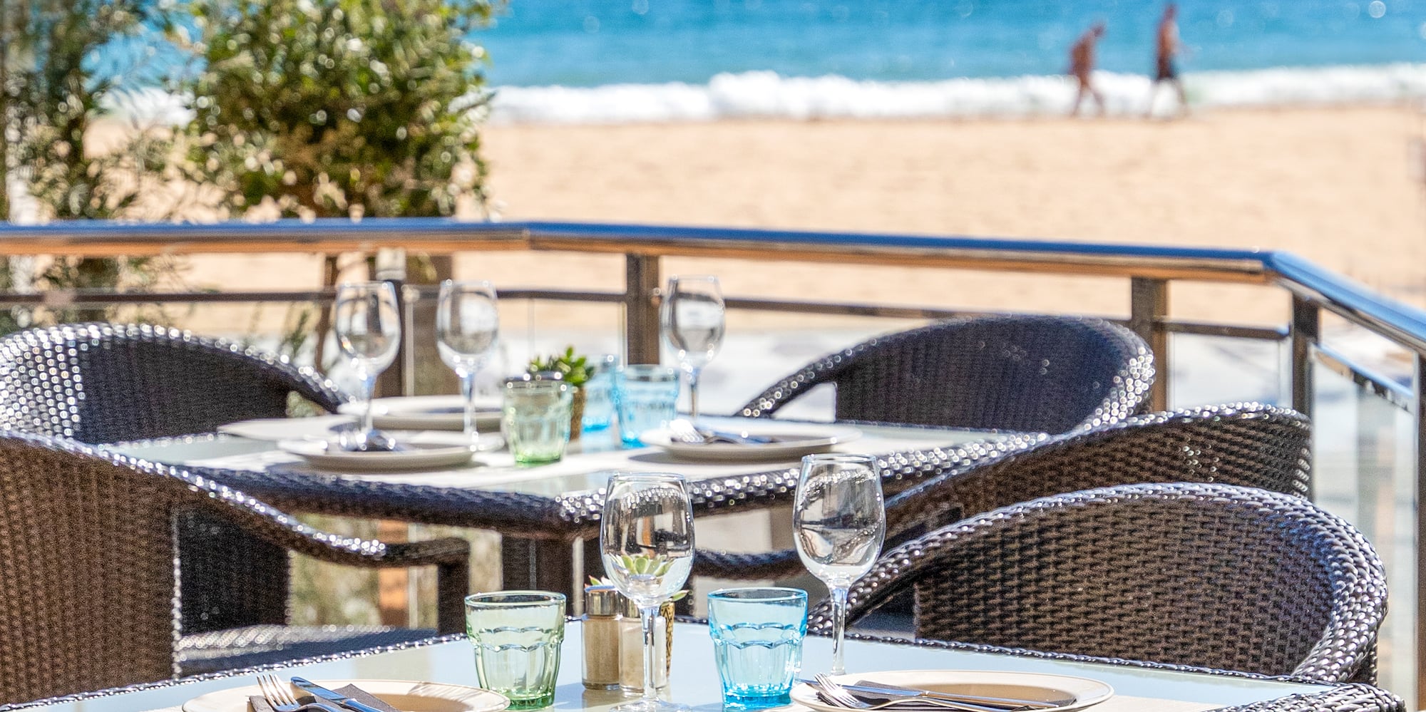 a table and chairs on a beach