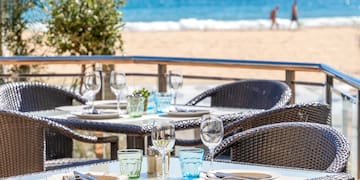 a table and chairs on a beach