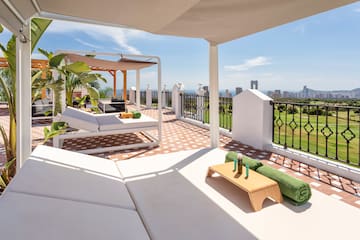 a patio with a view of a city and a city skyline