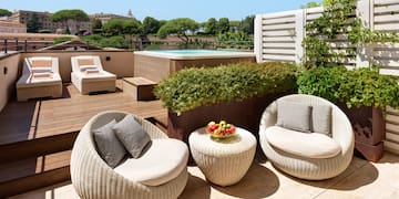 a patio with chairs and a pool