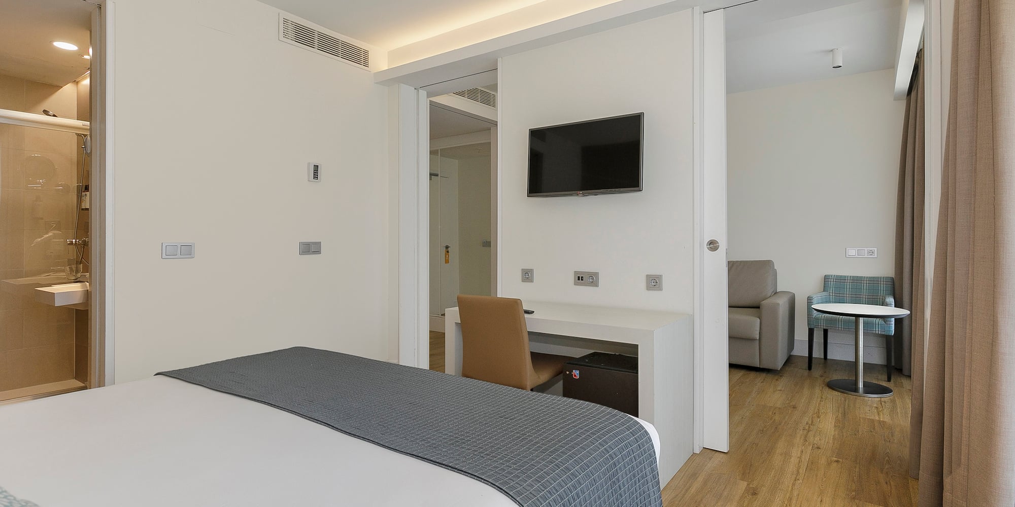 a bedroom with a tv and a table