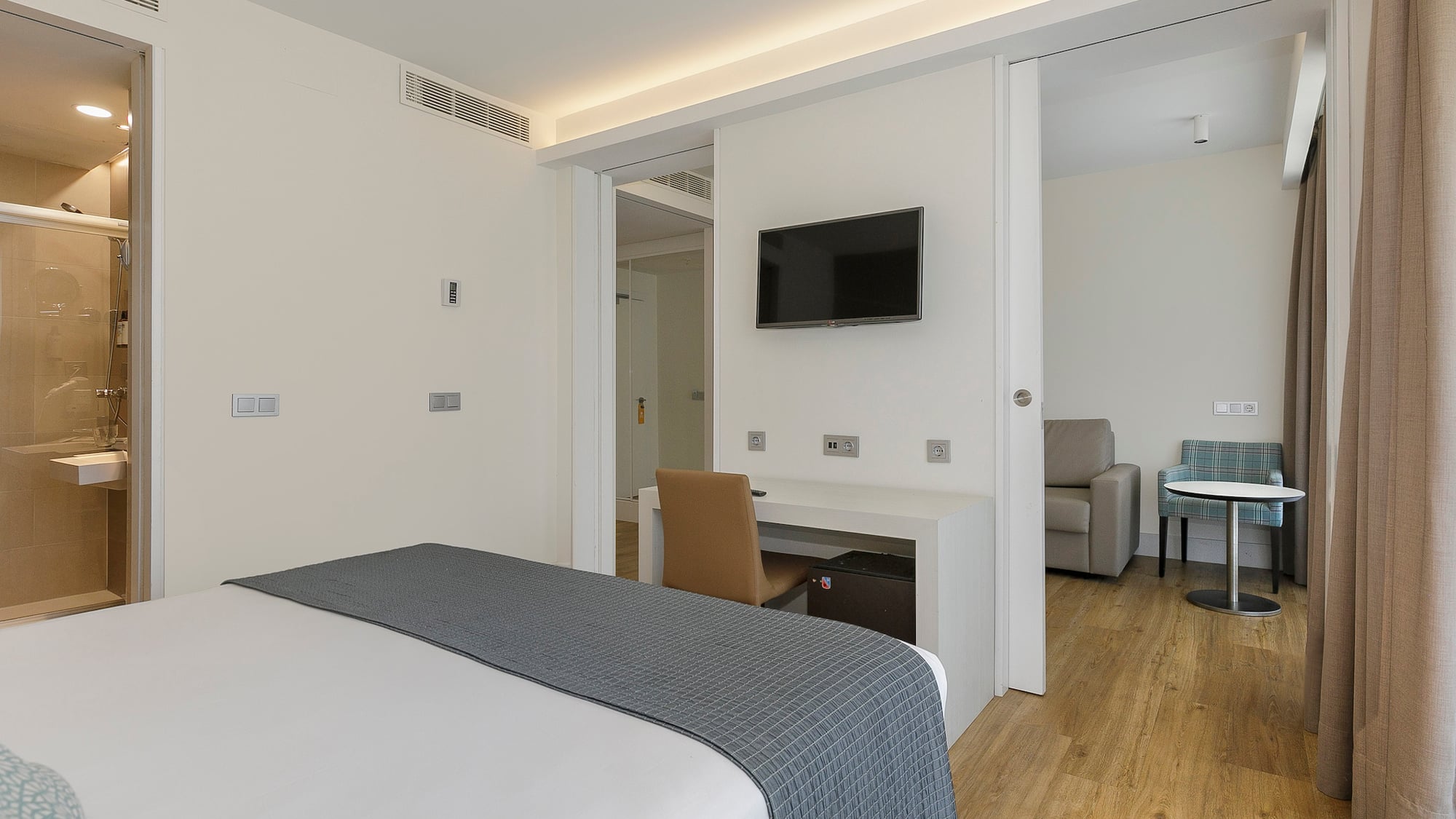 a bedroom with a tv and a table