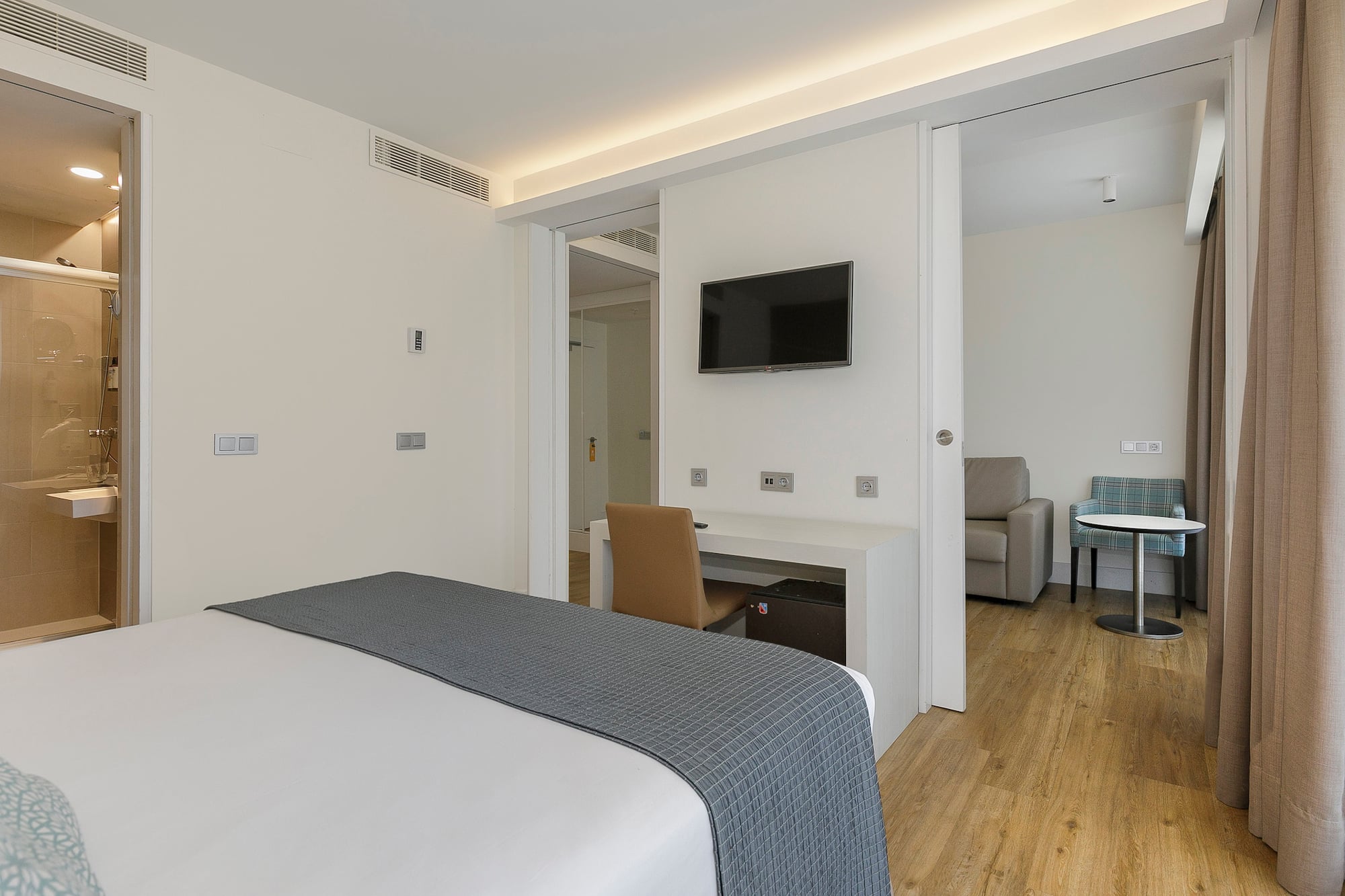 a bedroom with a tv and a table