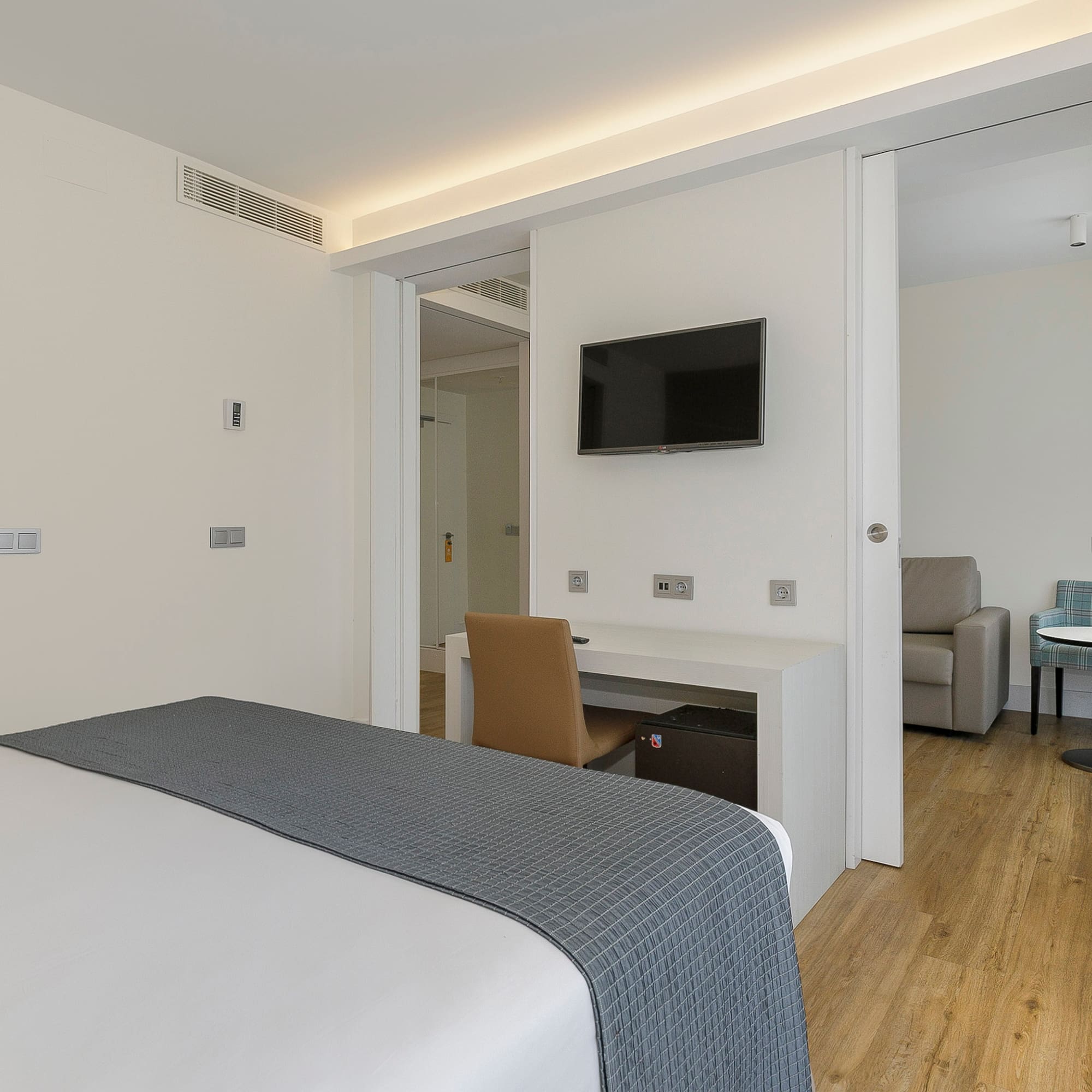 a bedroom with a tv and a table