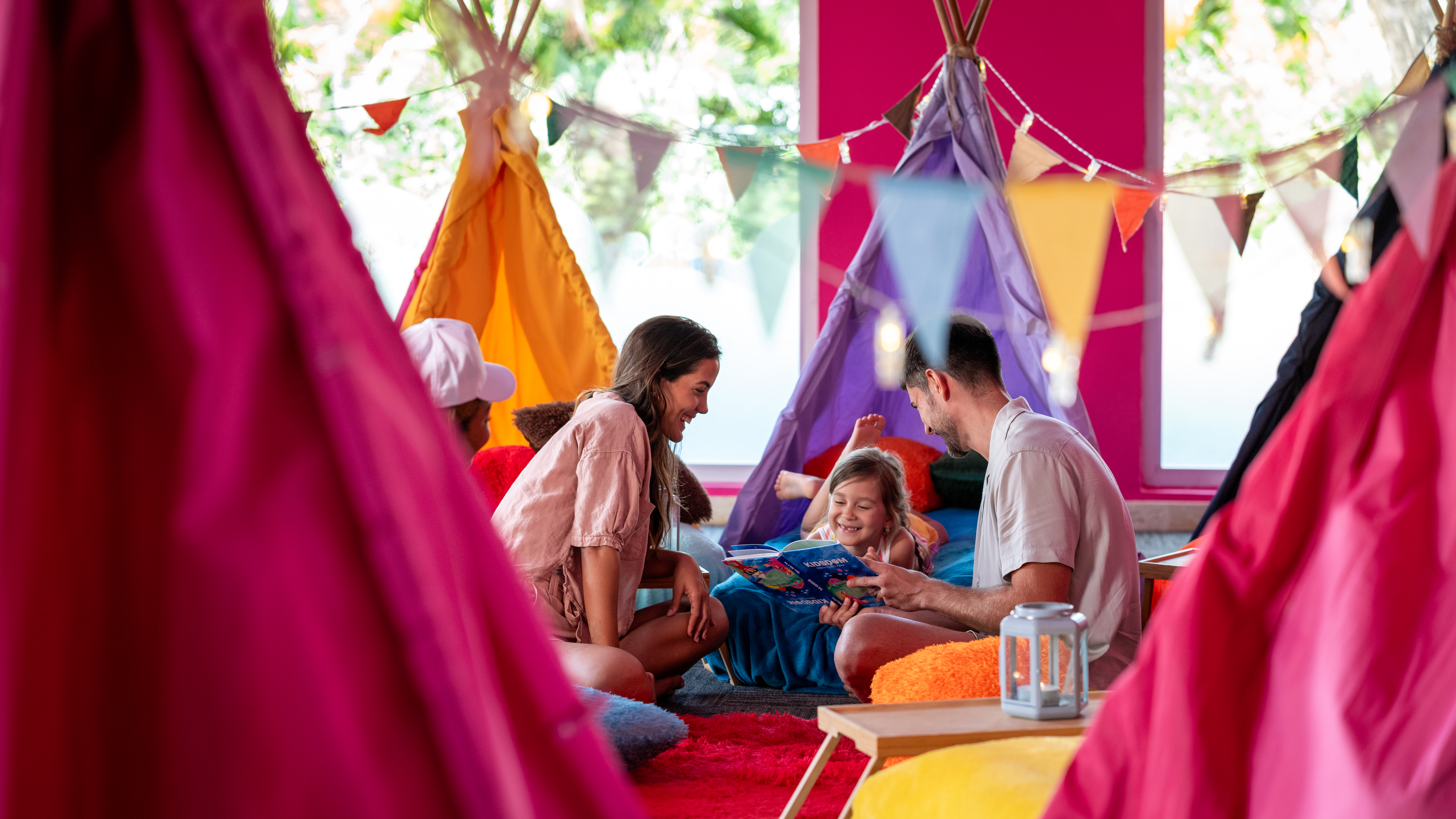 a group of people sitting on the floor with a book