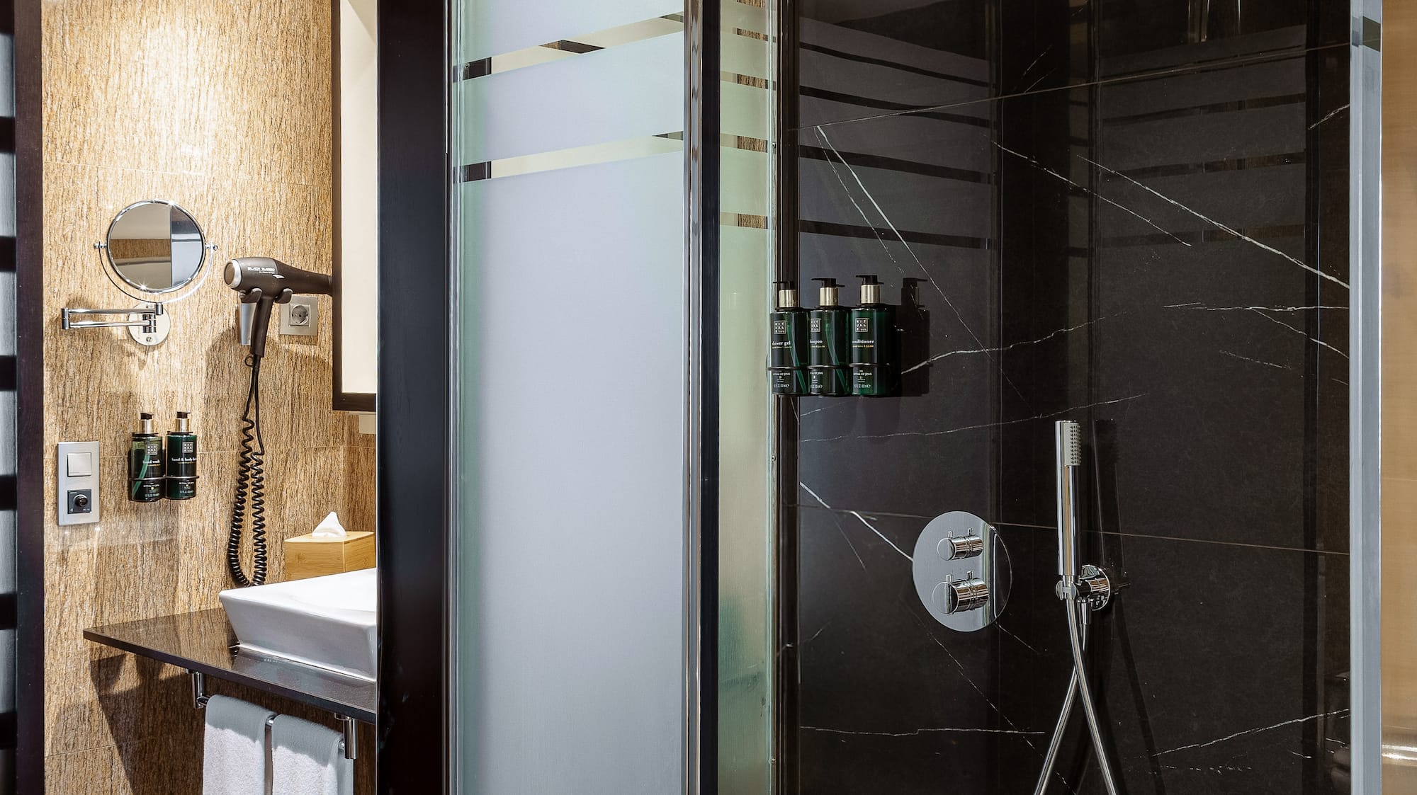 a shower with a black glass door