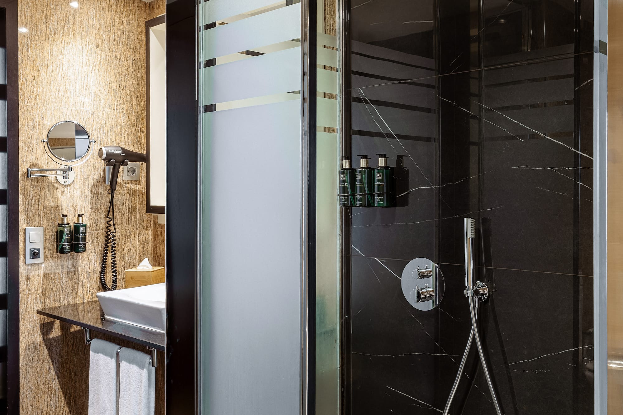 a shower with a black glass door