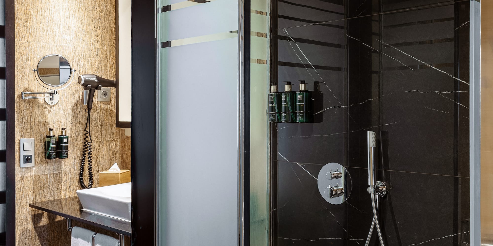 a shower with a black glass door