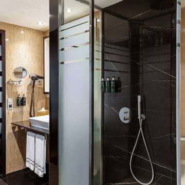 a shower with a black glass door