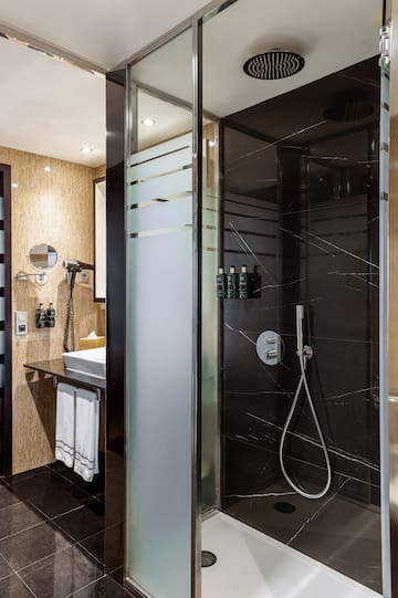 a shower with a black glass door