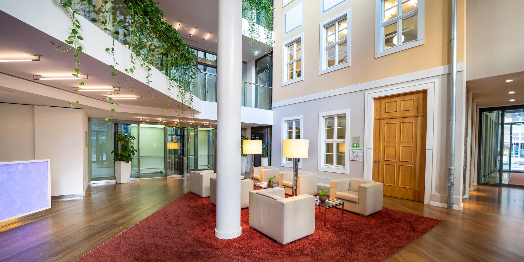 a room with a red rug and white furniture