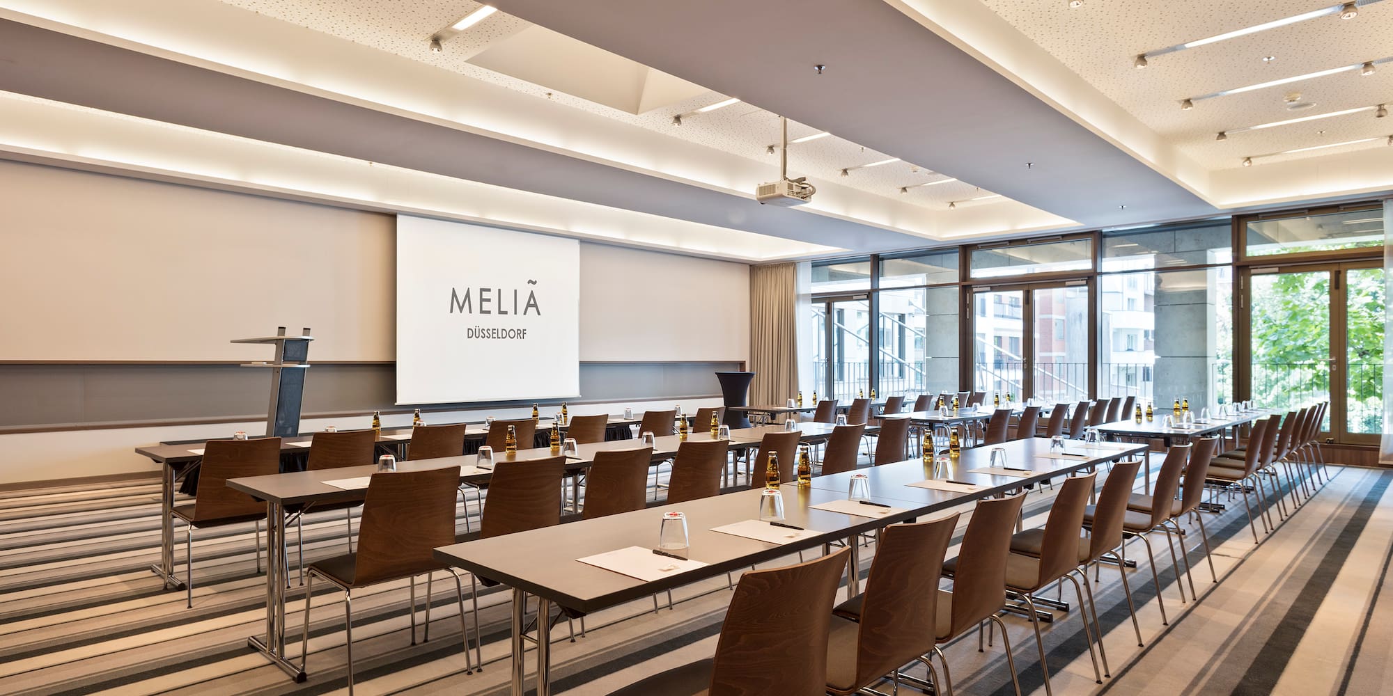 a room with long tables and chairs