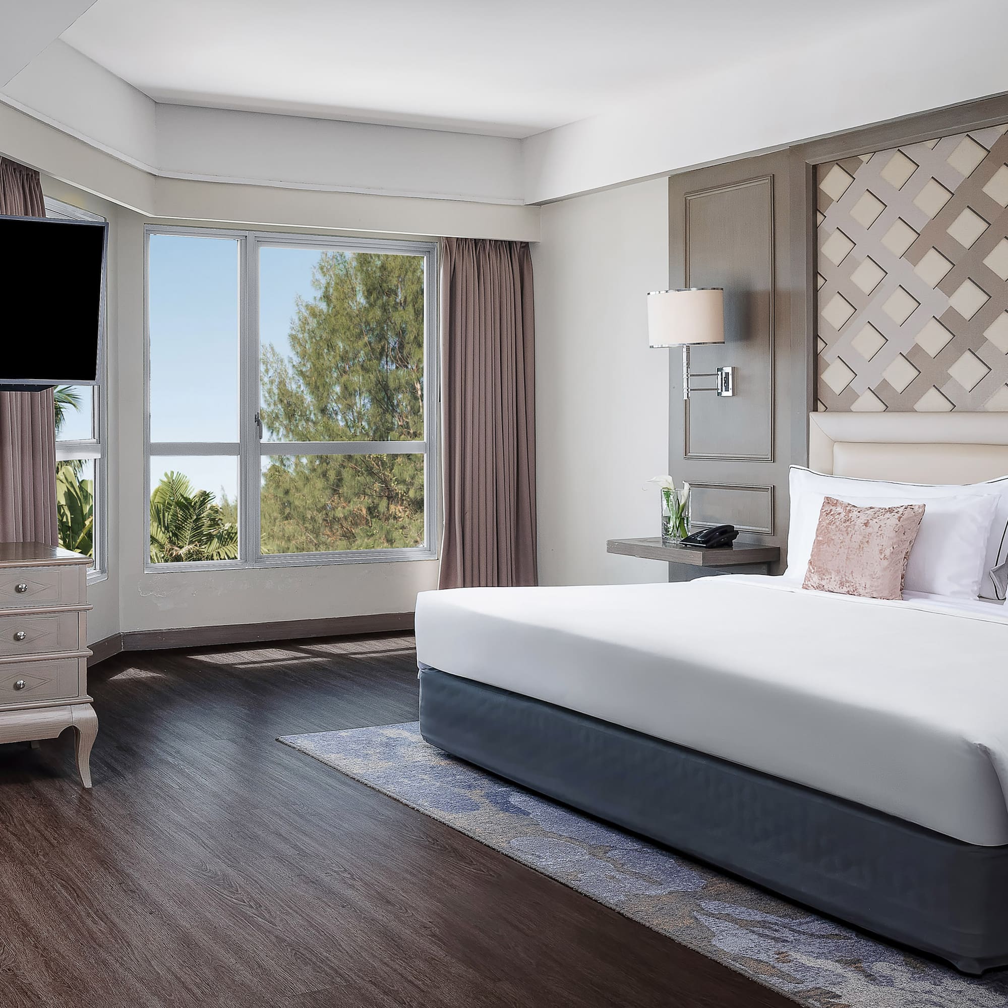 a bedroom with a large bed and a television