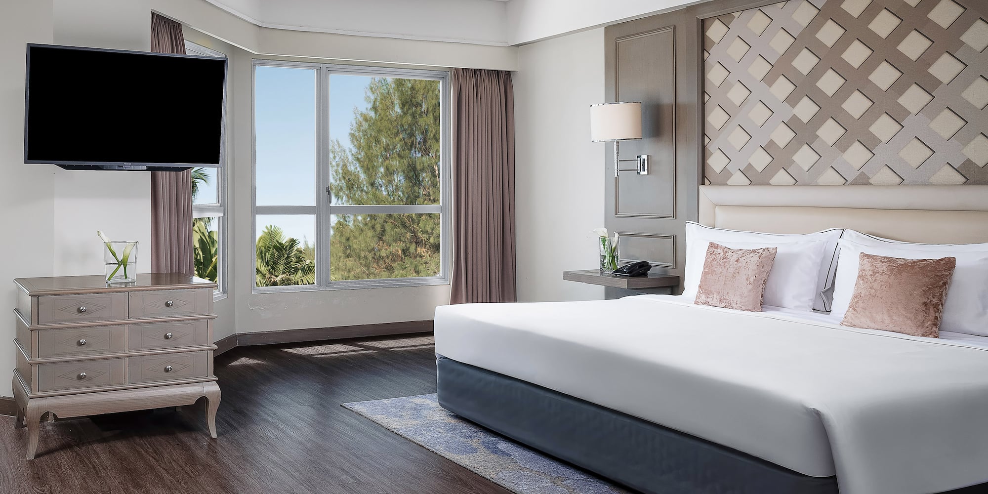 a bedroom with a large bed and a television