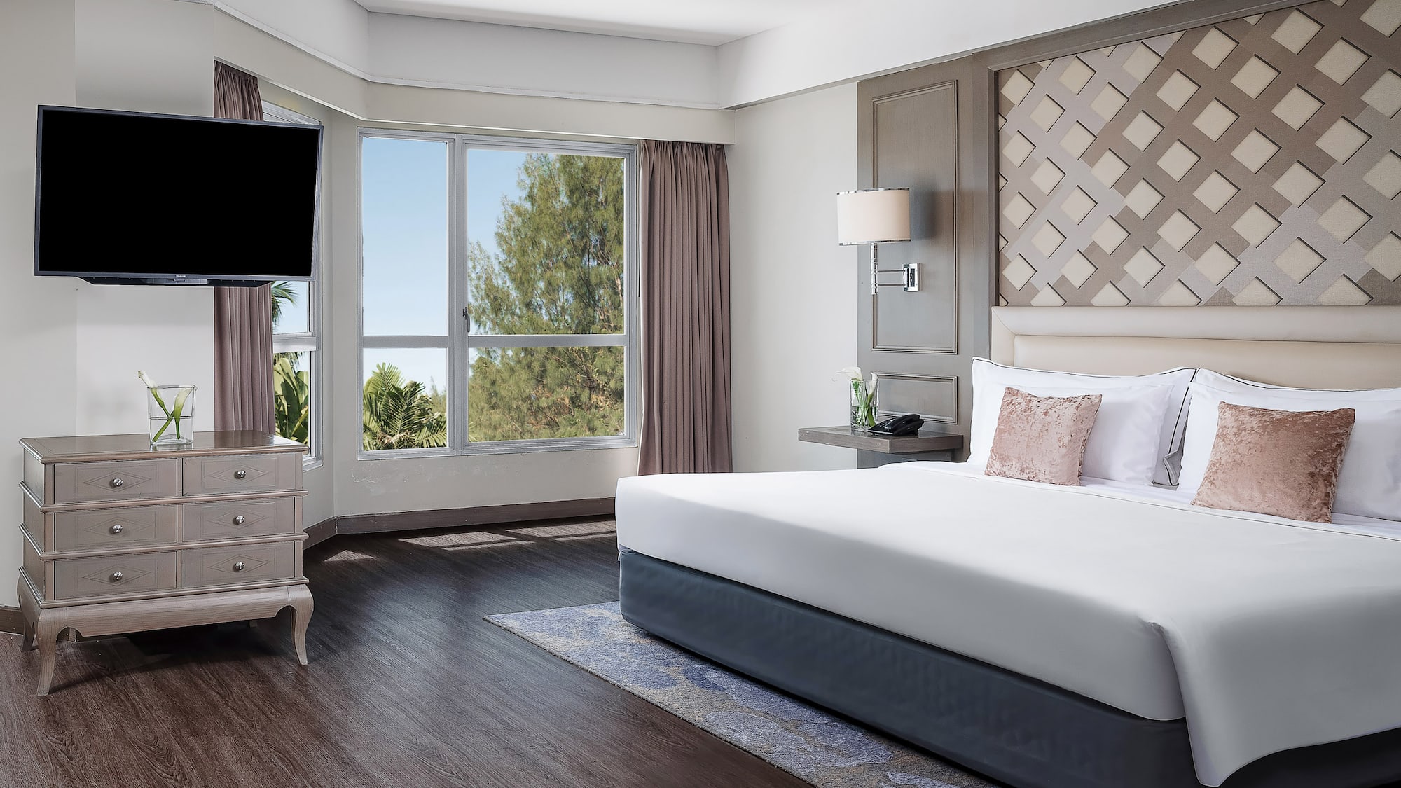 a bedroom with a large bed and a television