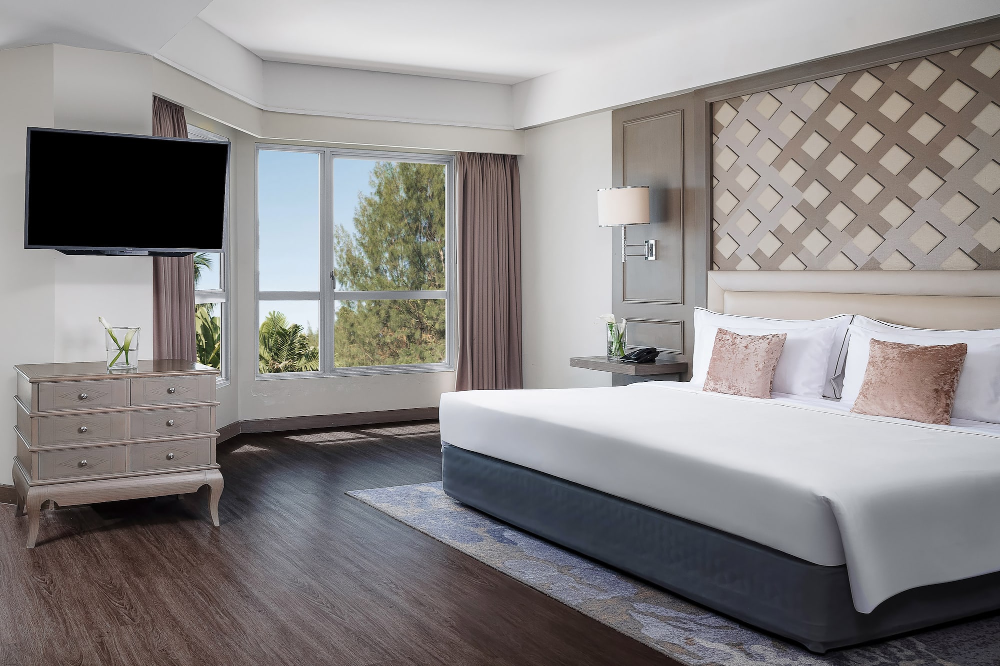 a bedroom with a large bed and a television