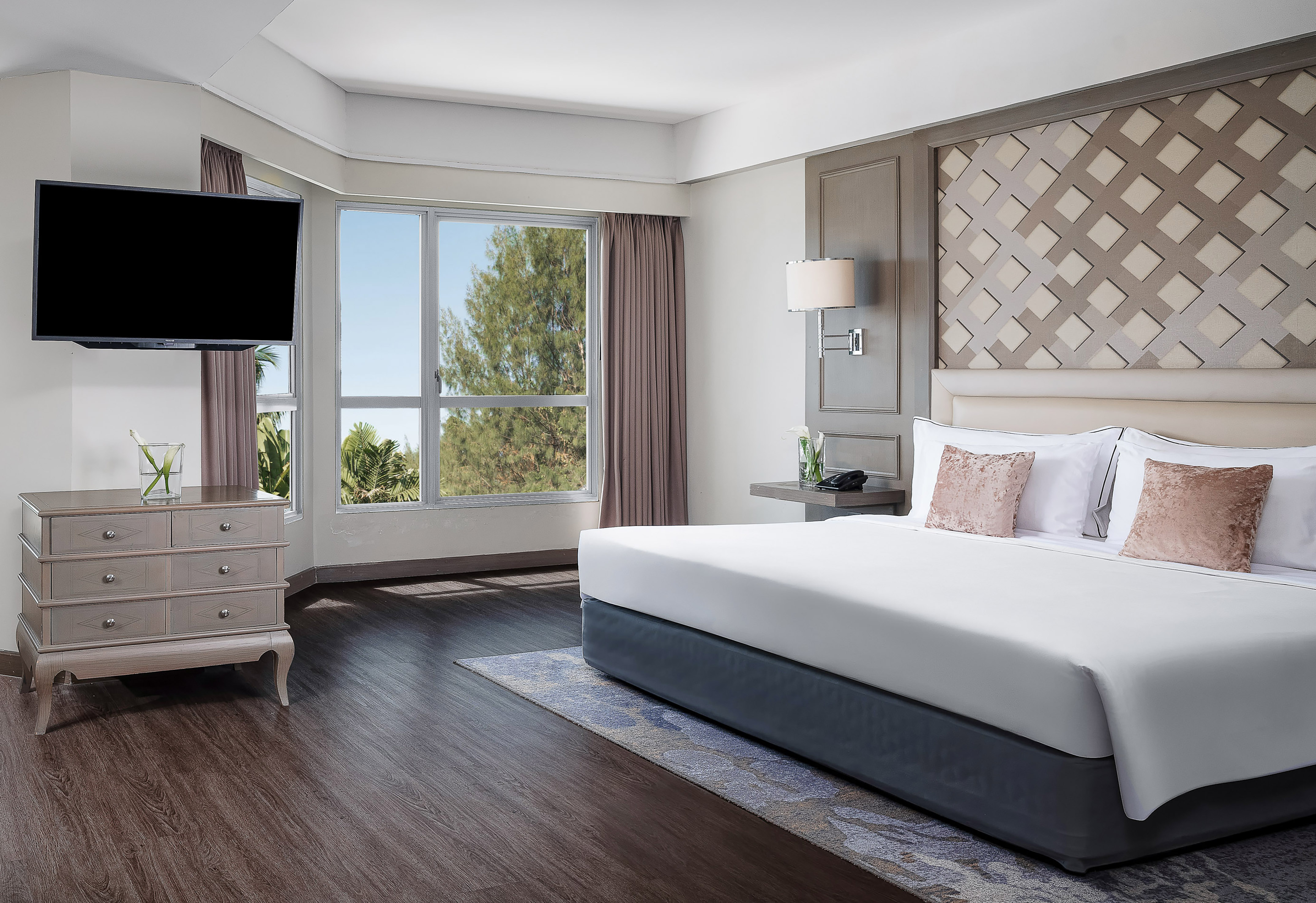 a bedroom with a large bed and a television