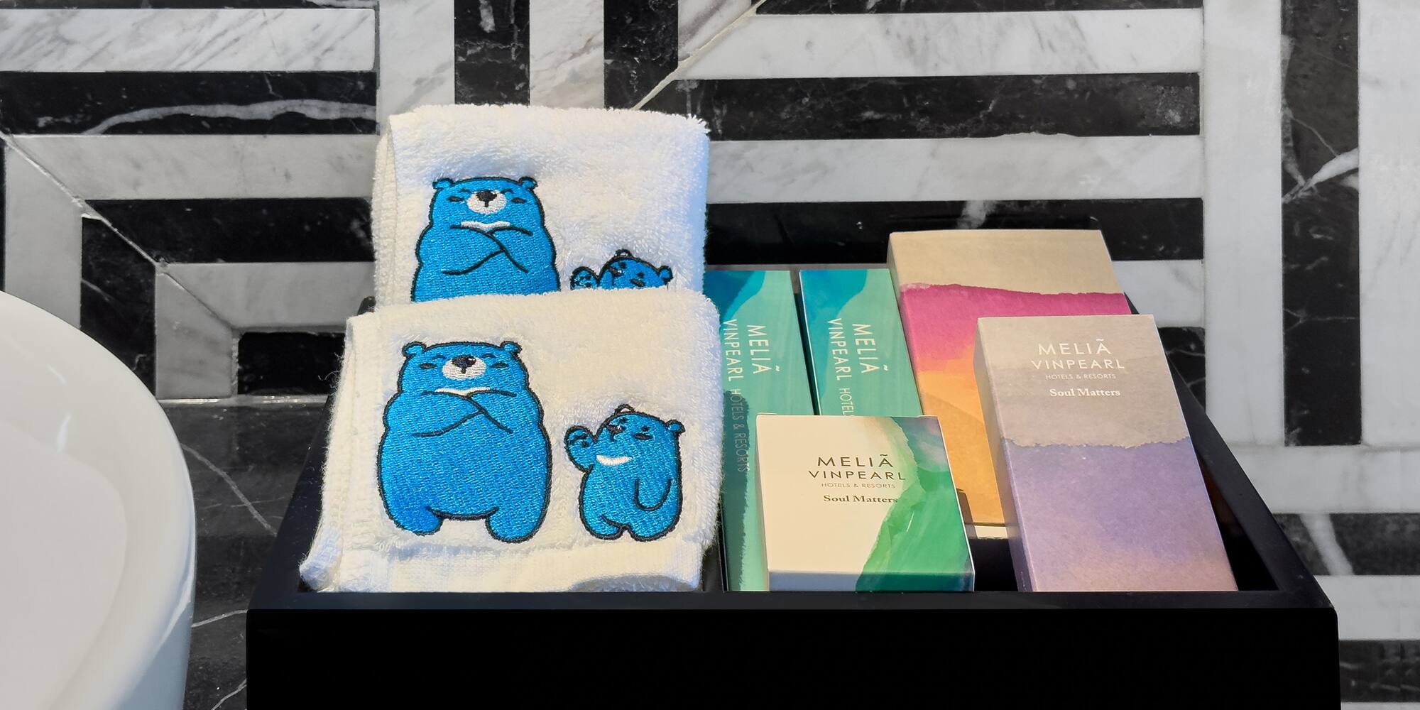 a black tray with towels and books on it