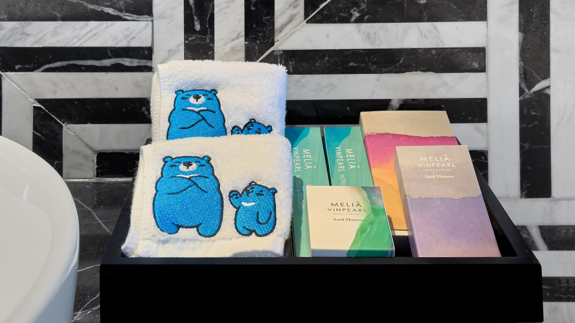 a black tray with towels and books on it