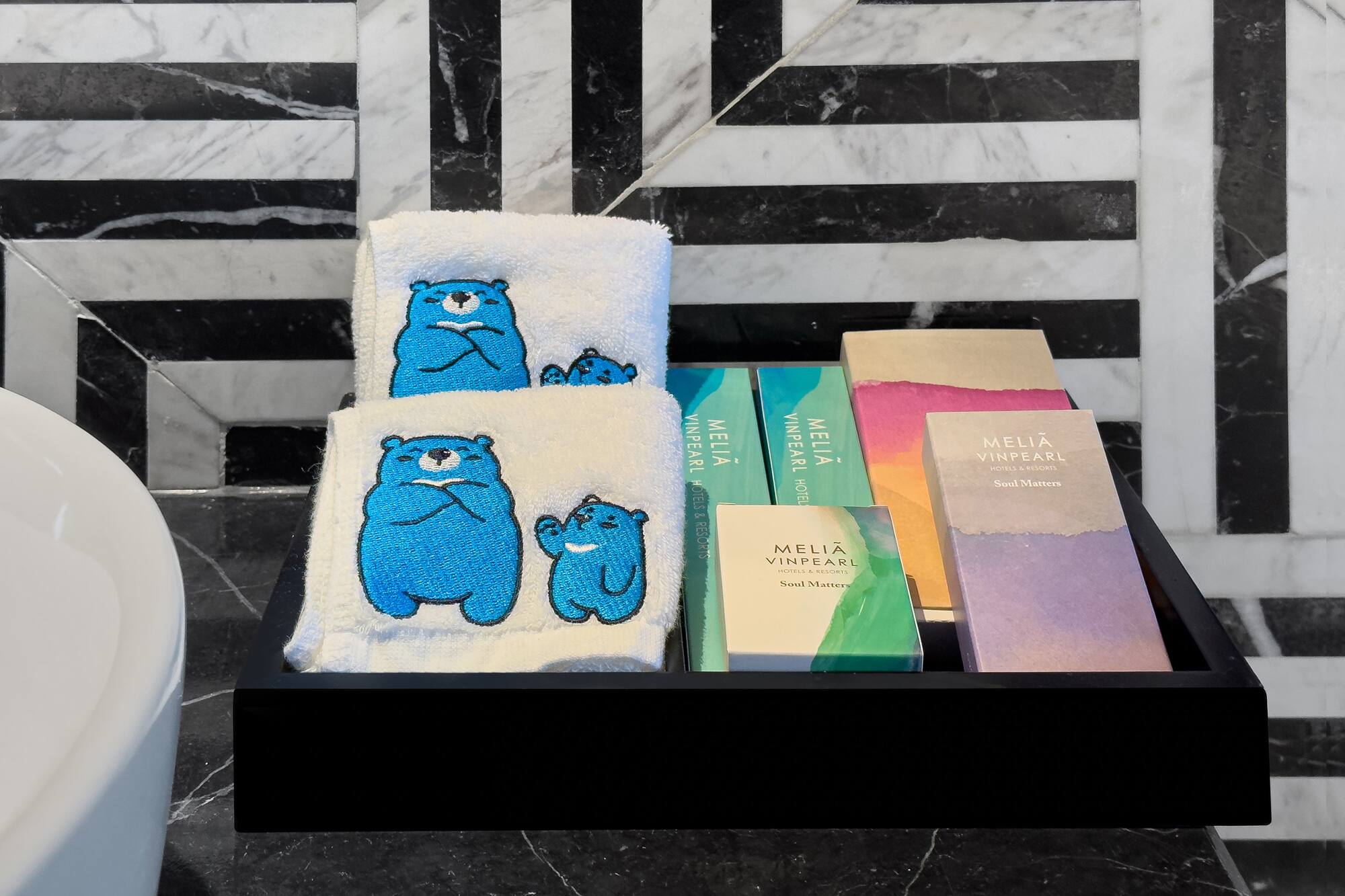 a black tray with towels and books on it