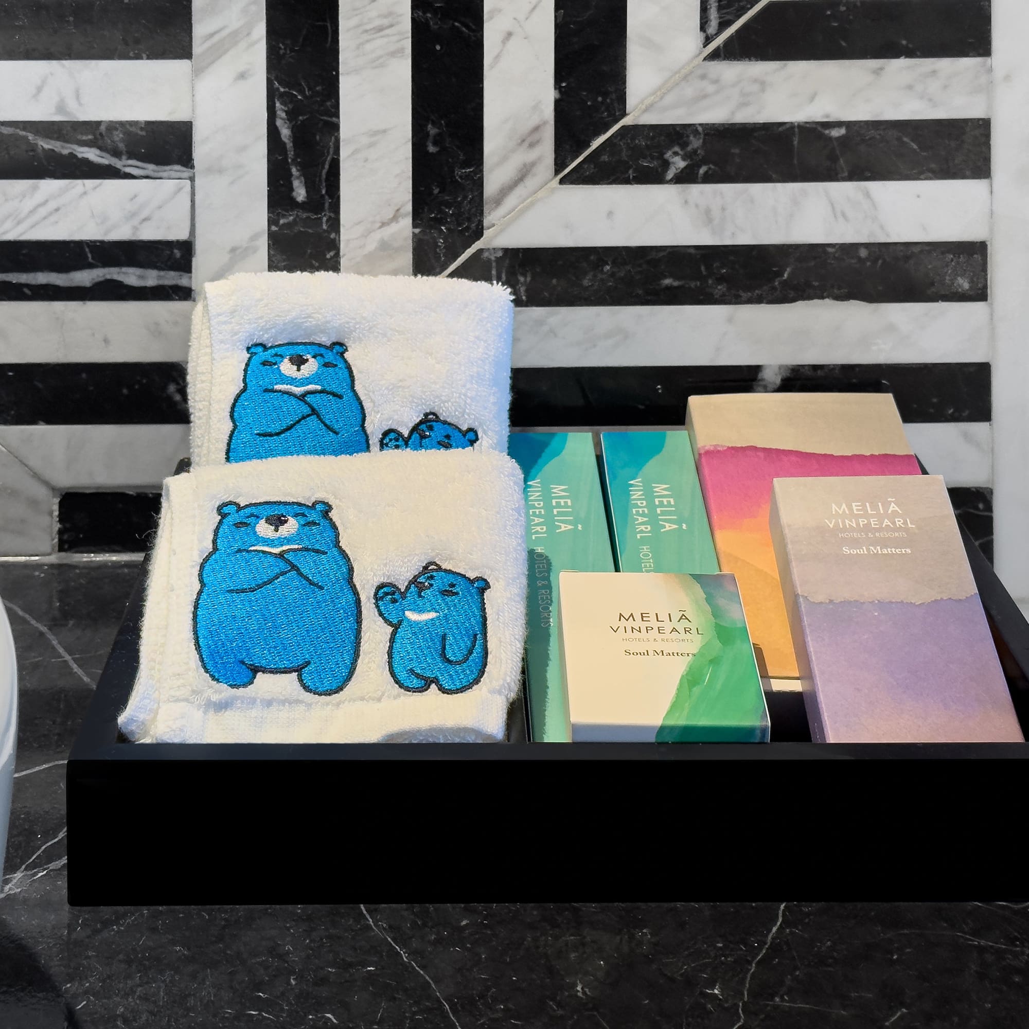 a black tray with towels and books on it