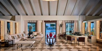 a room with a checkered floor and a table and chairs