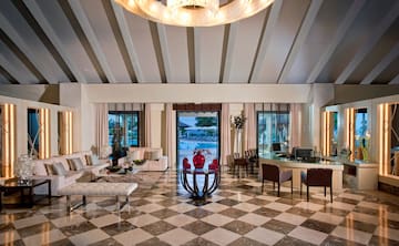 a room with a checkered floor and a table and chairs