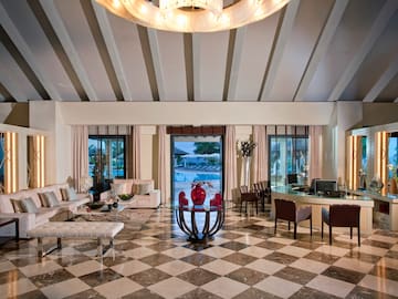 a room with a checkered floor and a table and chairs