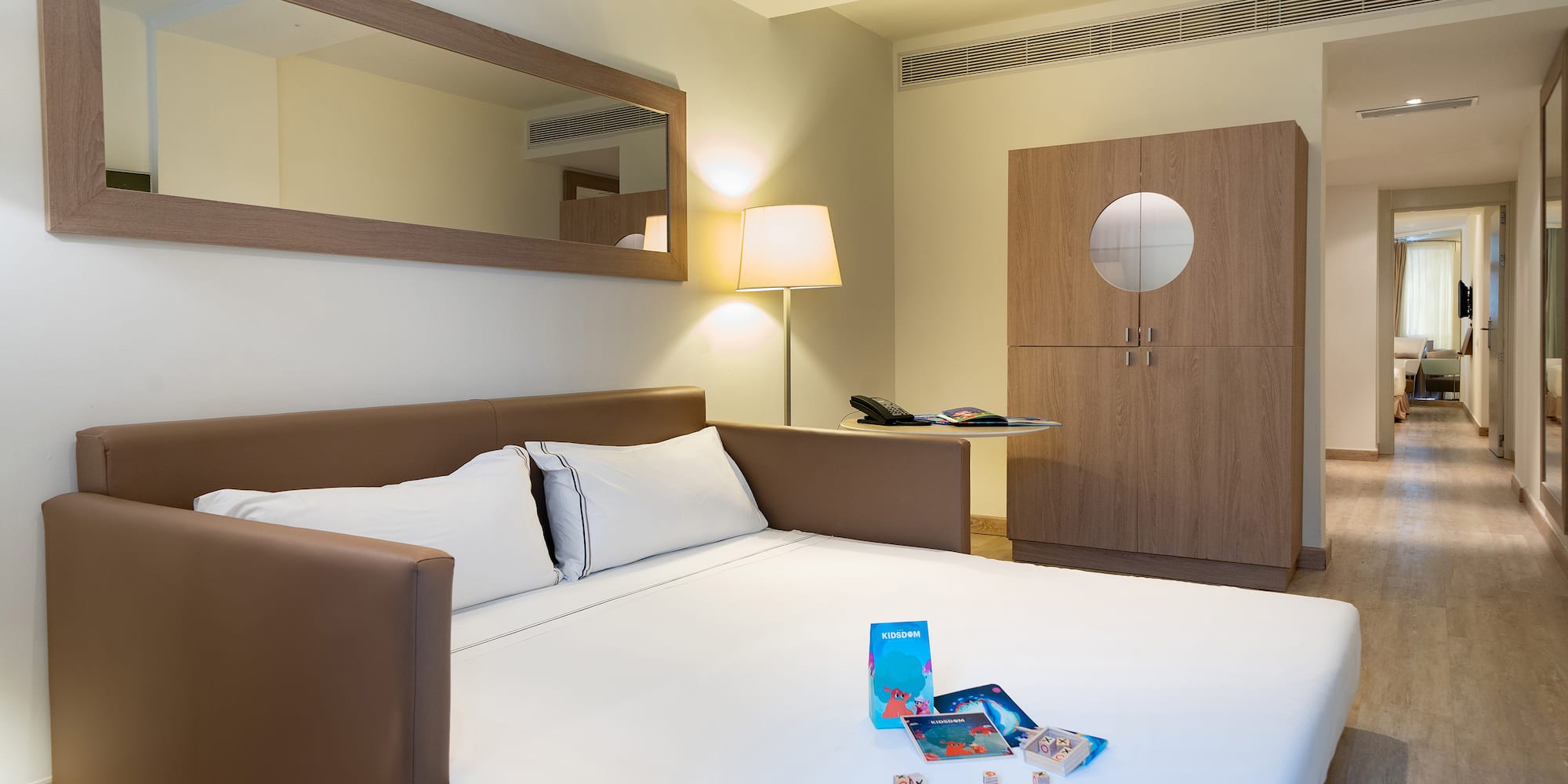 a bed with a white sheet and a lamp