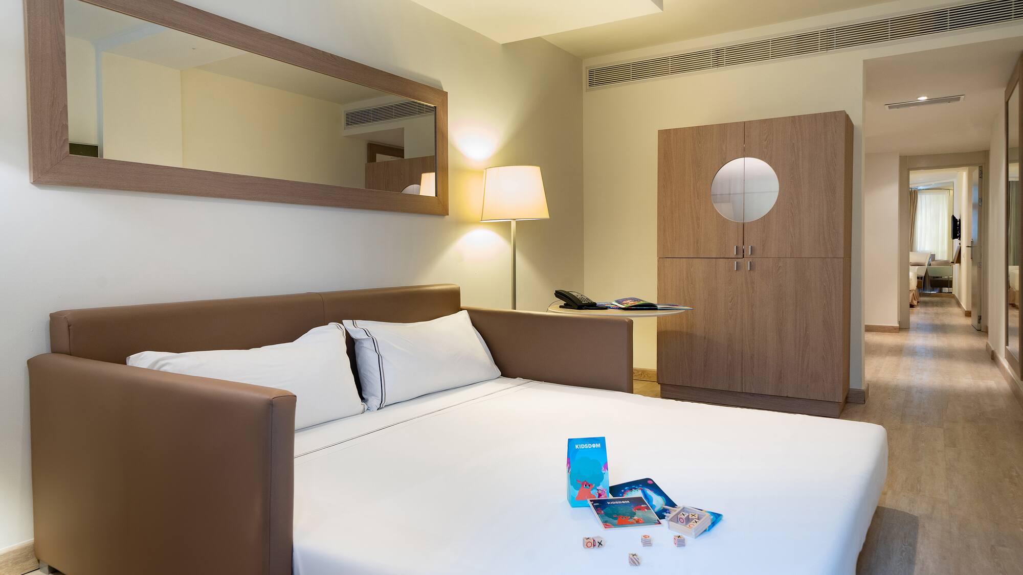 a bed with a white sheet and a lamp