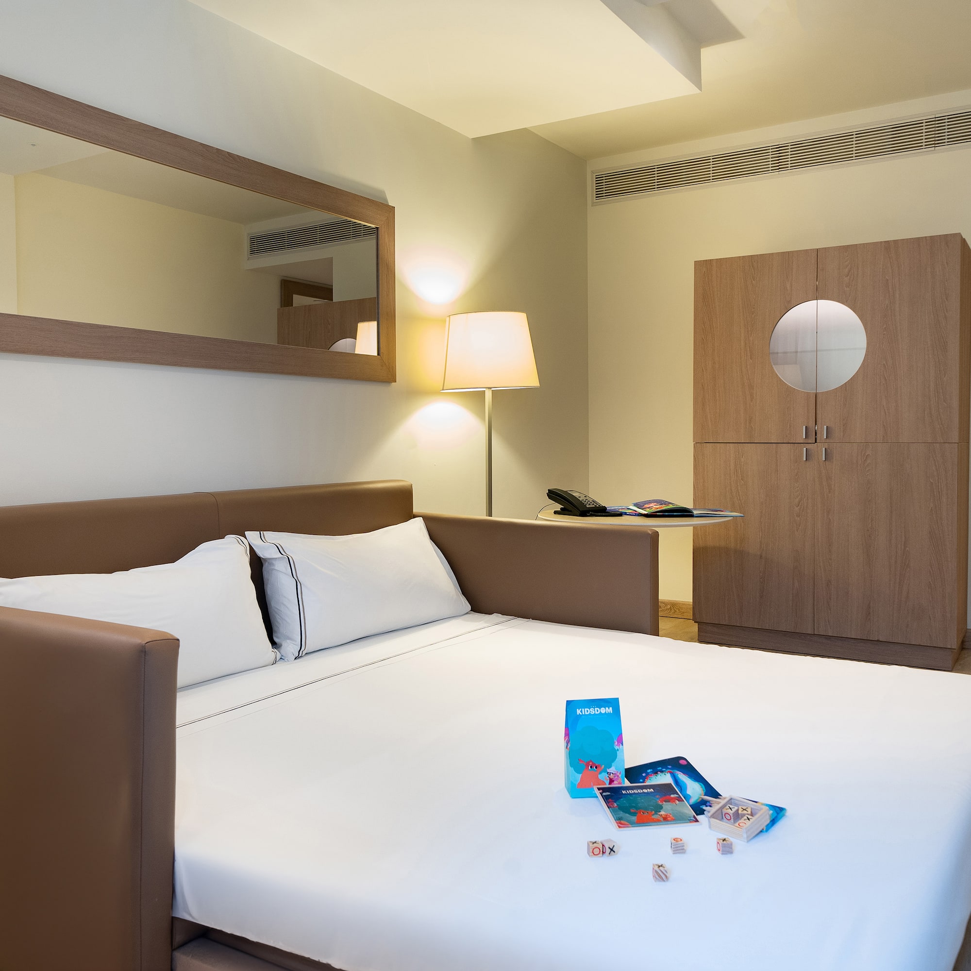 a bed with a white sheet and a lamp