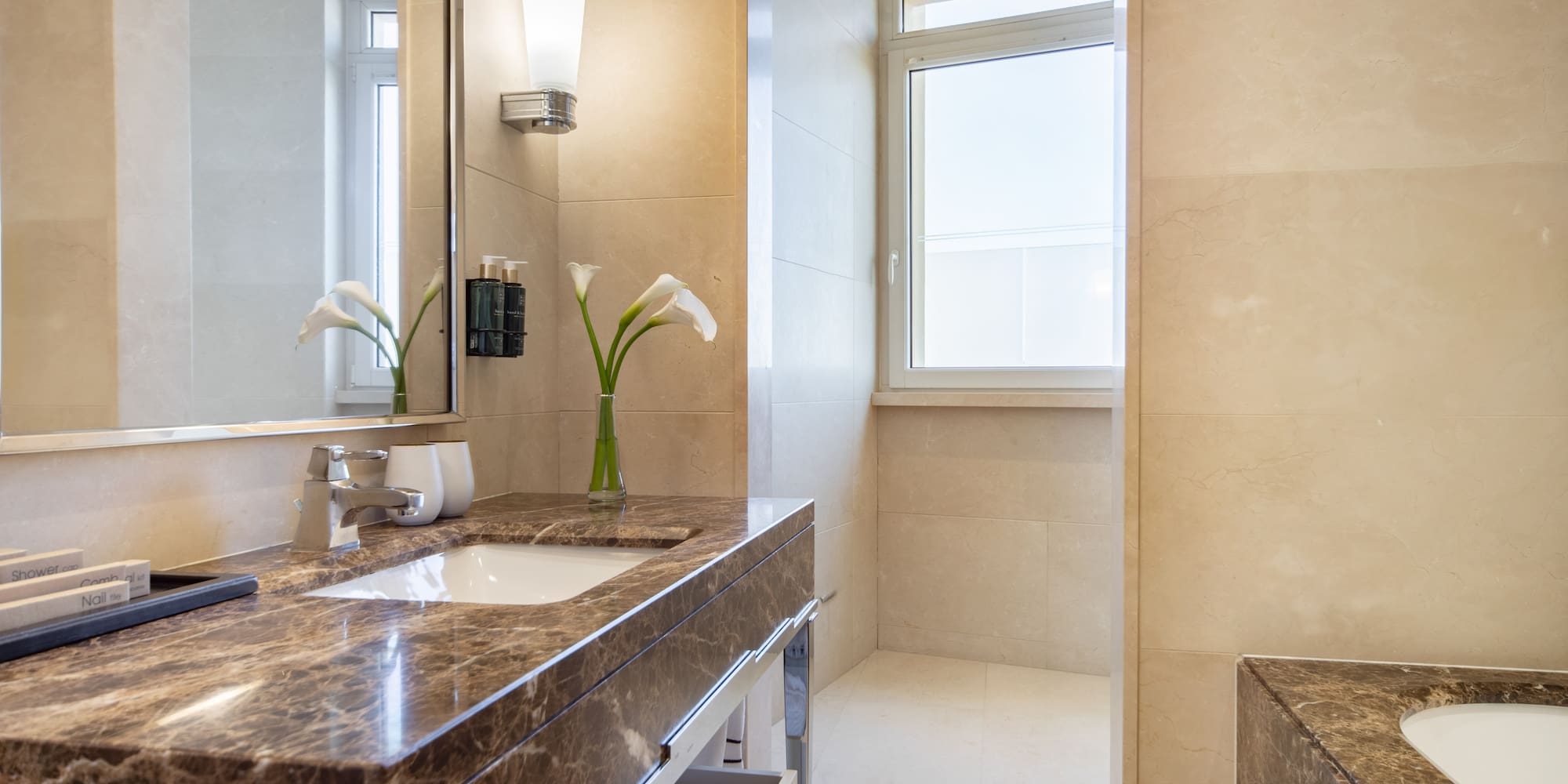 a bathroom with a marble countertop and a mirror