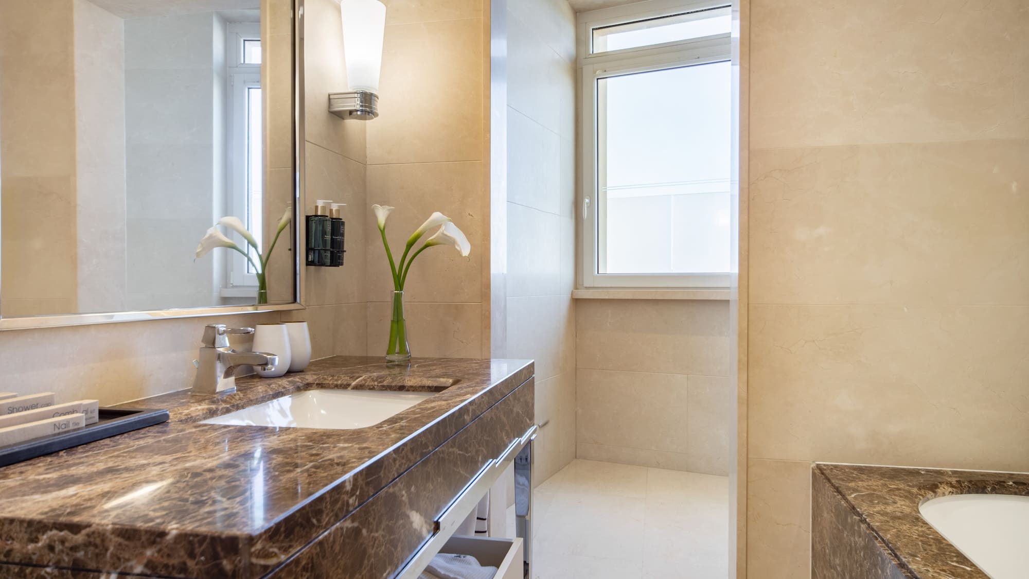 a bathroom with a marble countertop and a mirror