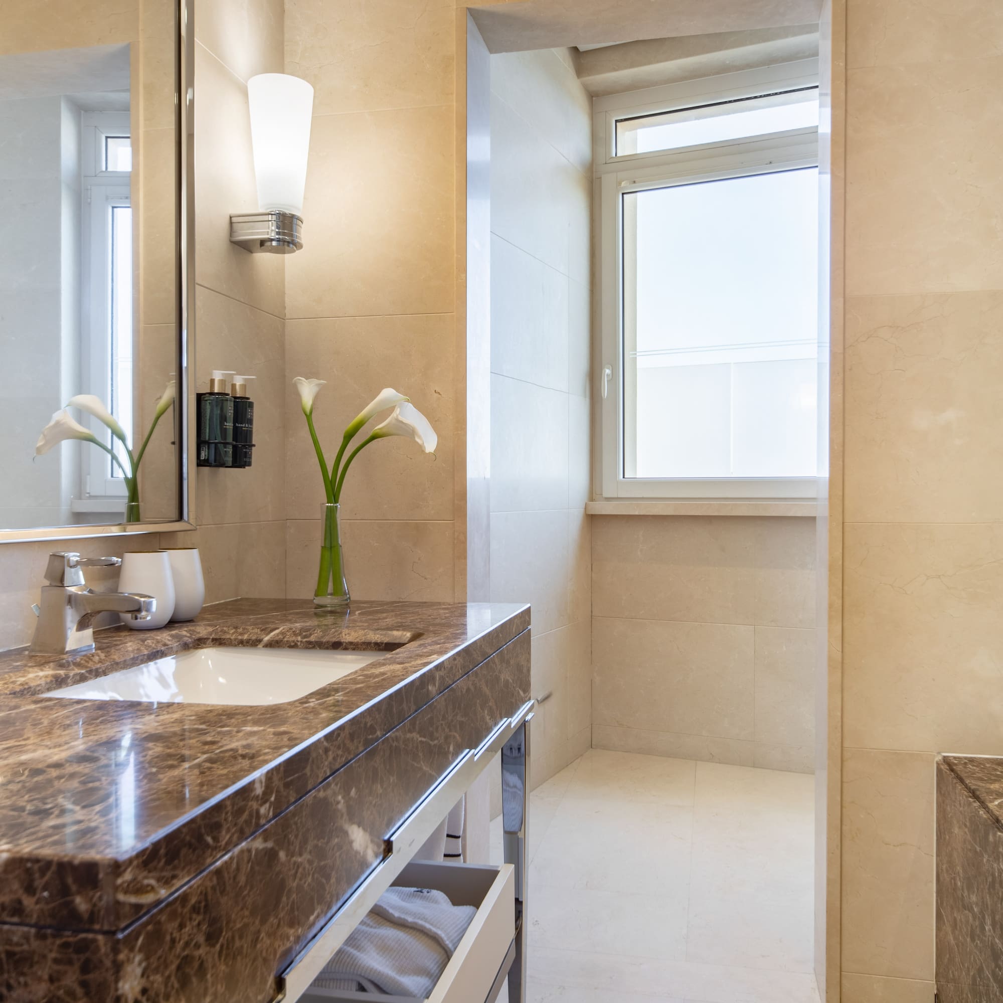a bathroom with a marble countertop and a mirror