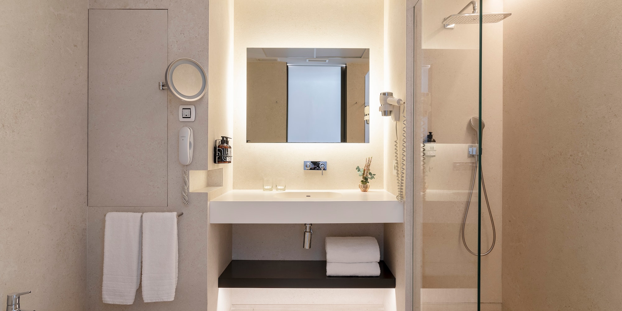 a bathroom with a glass shower and sink
