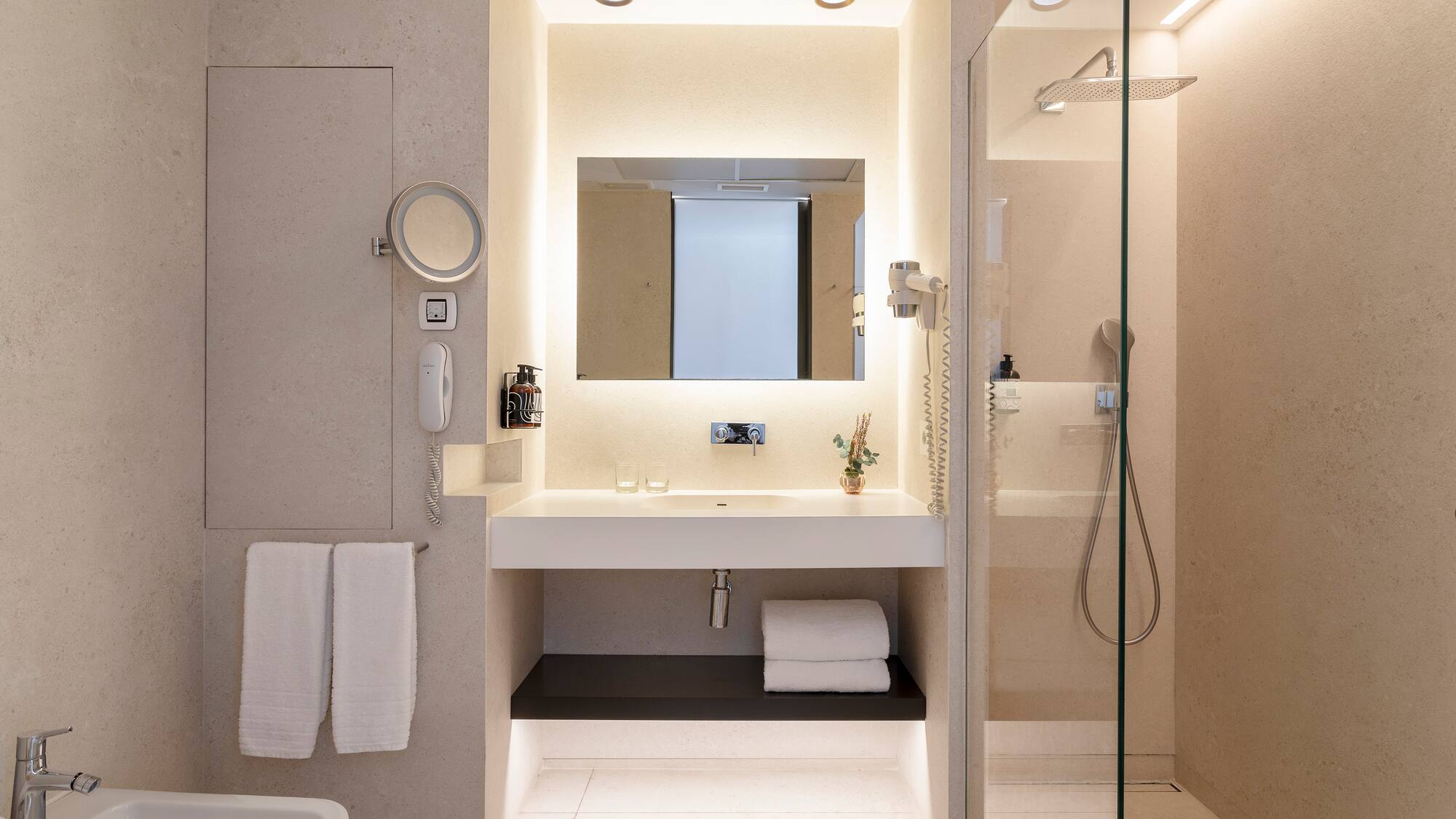 a bathroom with a glass shower and sink