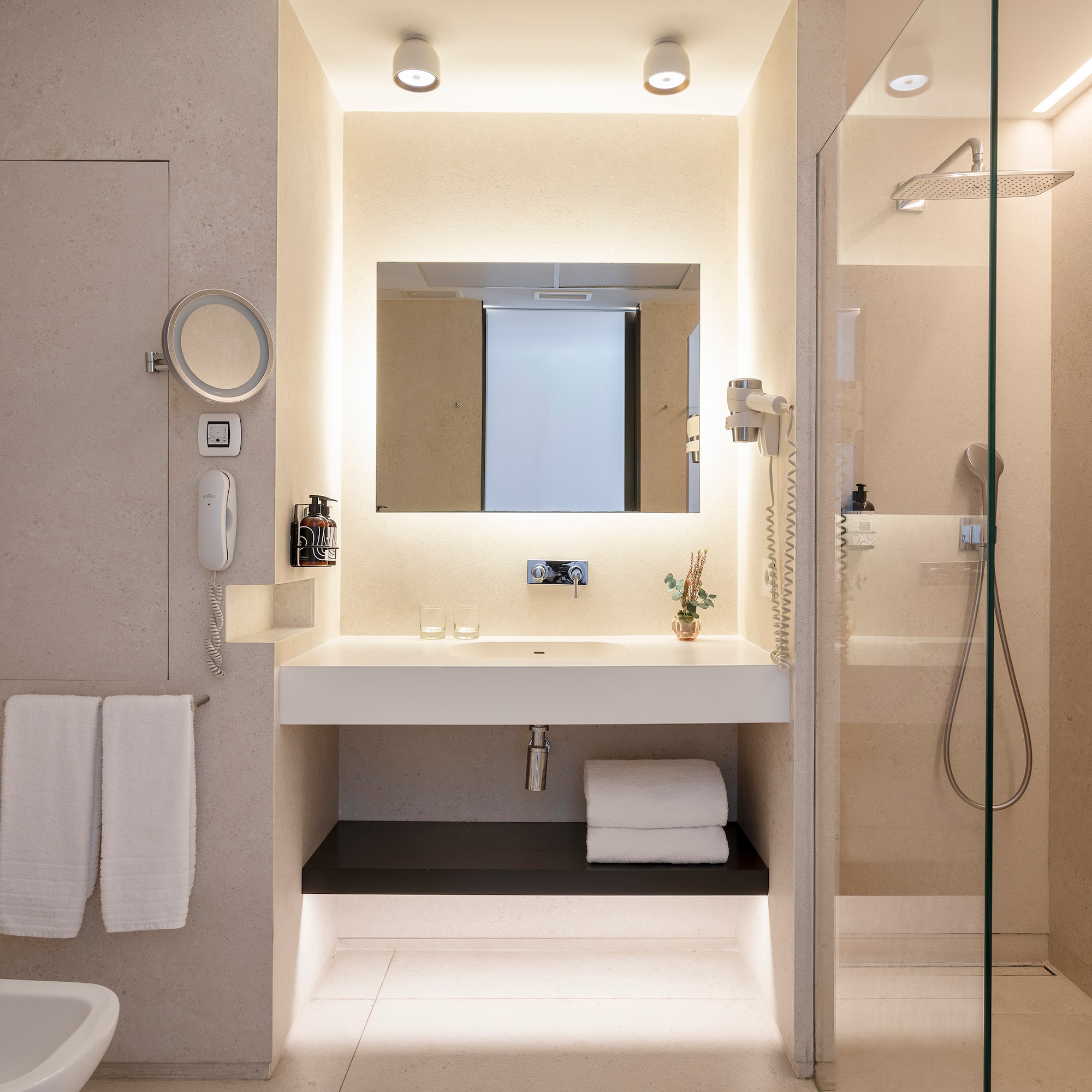 a bathroom with a glass shower and sink