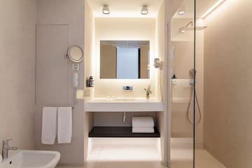 a bathroom with a glass shower and sink